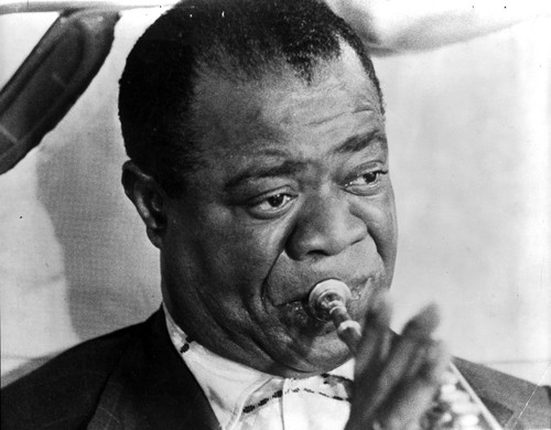 Louis Armstrong playing a trumpet Photo Print - Item # VARCEL696814
