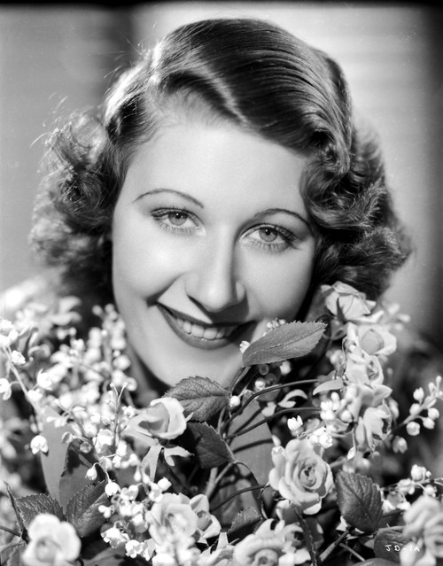 Joan Davis smiling while Surrounded by Flowers Photo Print - Item # VARCEL697115