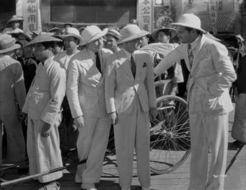 Jean Harlow Scene from a Film Three Men standing on a Public Market in White Hat and Linen Tweed Suit Photo Print - Item # VARCEL697161