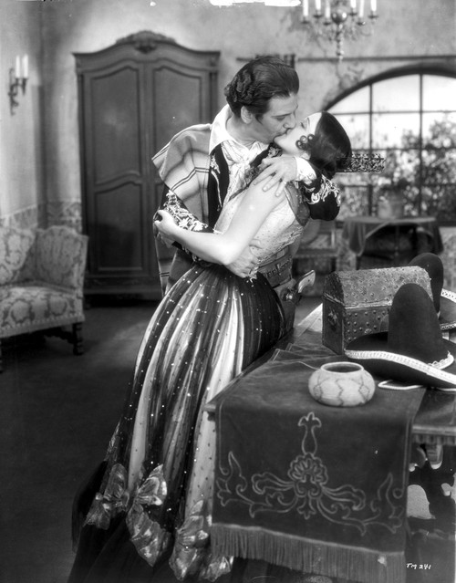 A Film Still Of Warner Baxter Kissing Co Star Photo Print - Item # VARCEL697147