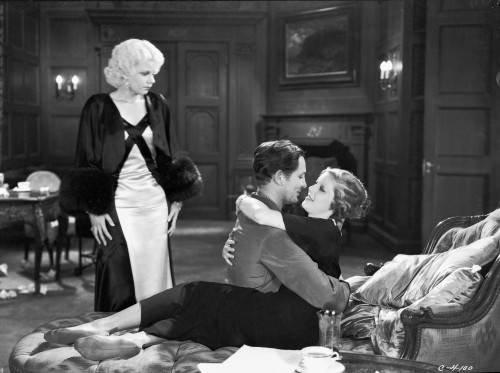 Jean Harlow Scene from a Film standing in Black Long Sleeve Silk Coat and White Halter Dress with Hands on the Side Photo Print - Item # VARCEL697182