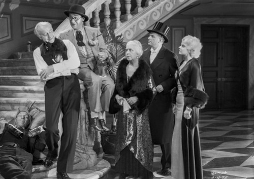 Jean Harlow Scene from a Film standing in White V-Neck Strap Top Dress and Black Long Sleeve Velvet Coat Photo Print - Item # VARCEL697184