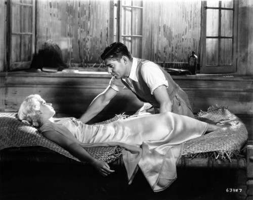 Jean Harlow Scene from a Film sitting on a Straw Covered Bed in White Silk Dress Photo Print - Item # VARCEL697190