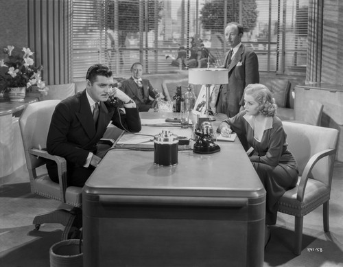 Jean Harlow Scene from a Film sitting In front of the Table in Black Long Sleeve Dress with Right Arm on the Table Photo Print - Item # VARCEL697275