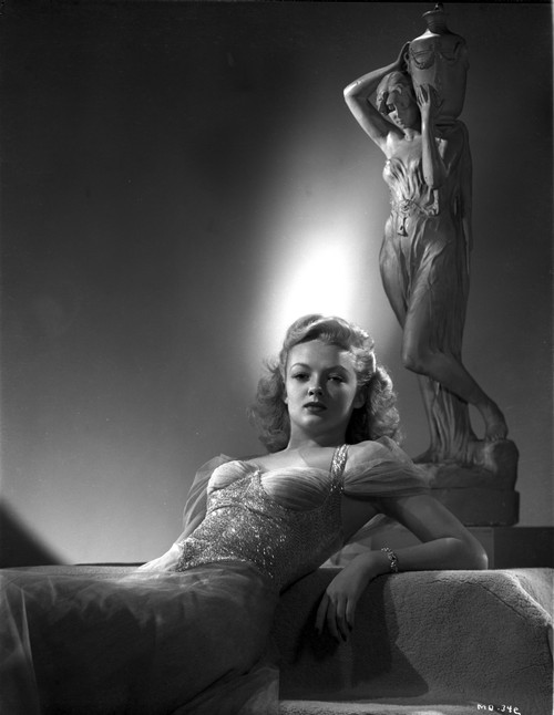 Myrna Dell Leaning Behind the Statue in Black and White Photo Print - Item # VARCEL697407