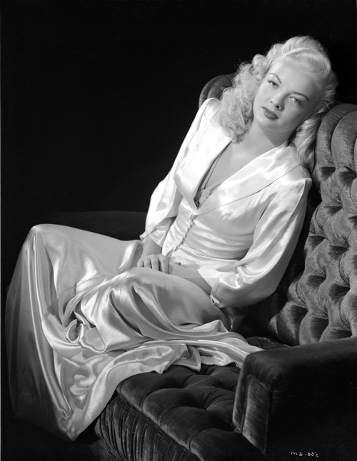 Myrna Dell sitting on Couch in Silk Dress in Black and White Photo Print - Item # VARCEL697425