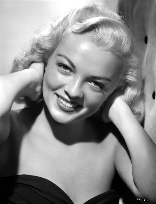 Myrna Dell smiling in A Portrait With Hands On Back of Neck in Black and White Photo Print - Item # VARCEL697440
