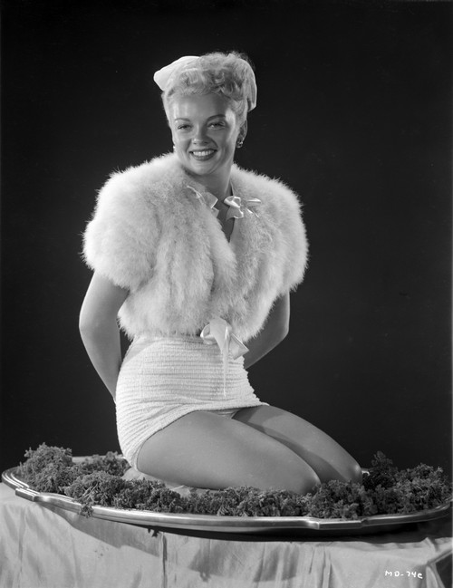 Myrna Dell Kneeling With Hands on Back in Sexy Fur Dress in Black and White Photo Print - Item # VARCEL697455