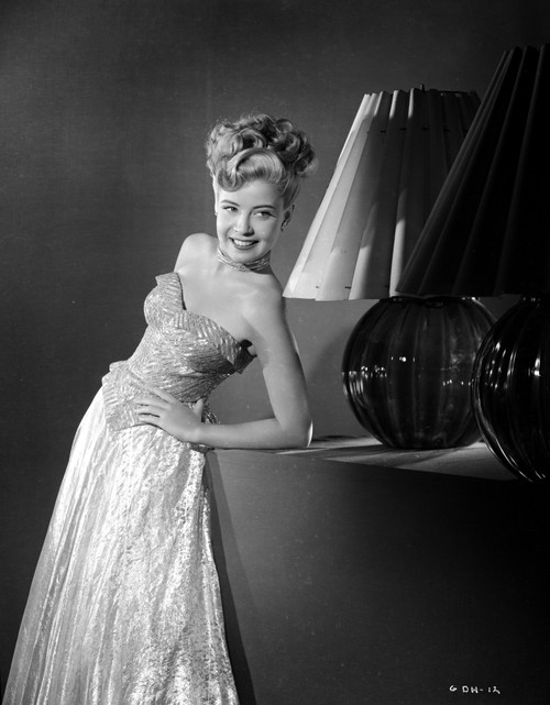 Gloria DeHaven Leaning On A Table in Gown in Black and White Photo Print - Item # VARCEL697520