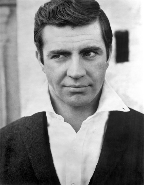 Alan Bates Posed in Black Suit With White Collar Photo Print