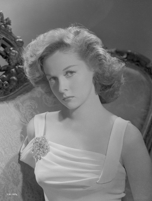 Susan Hayward sitting on a Chair in Dress with Brooch Photo Print - Item # VARCEL697560