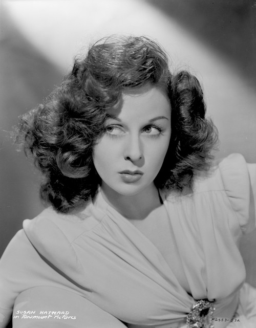 Susan Hayward sitting on a Couch in Dress Photo Print - Item # VARCEL697623