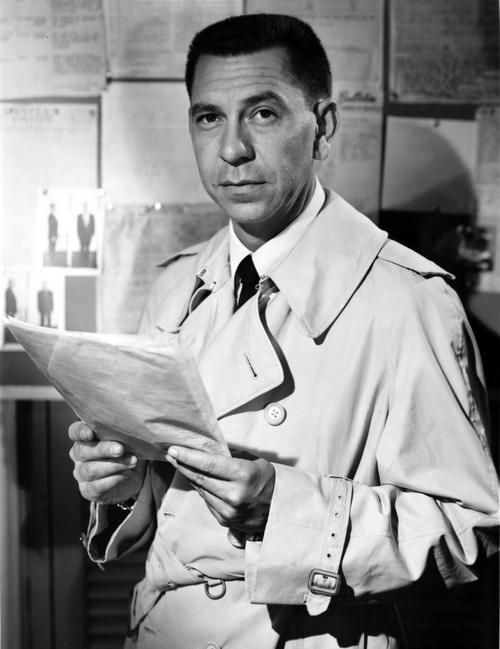Jack Webb Posed in Coat With Paper Photo Print - Item # VARCEL697694