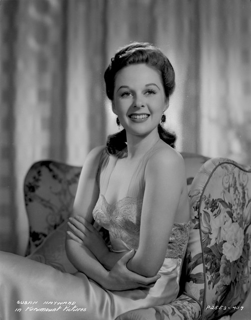 Susan Hayward sitting on a Printed Couch in Silk Dress Photo Print - Item # VARCEL697756