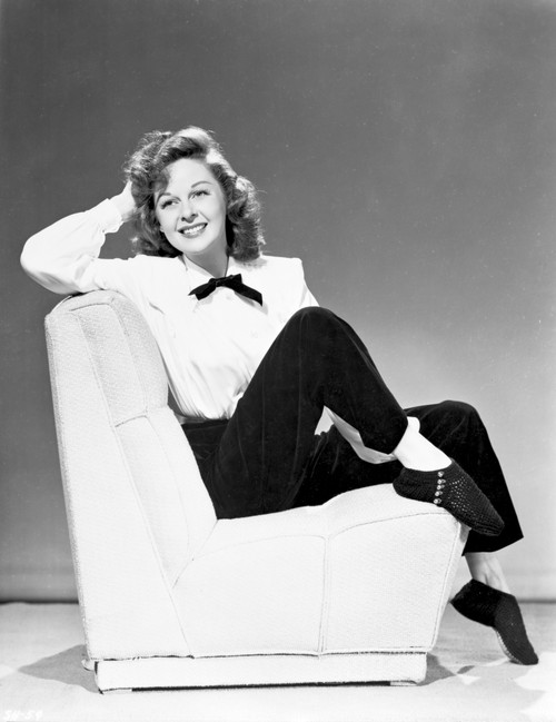 Susan Hayward sitting on Couch in White Long Sleeve Blouse Photo Print - Item # VARCEL697794