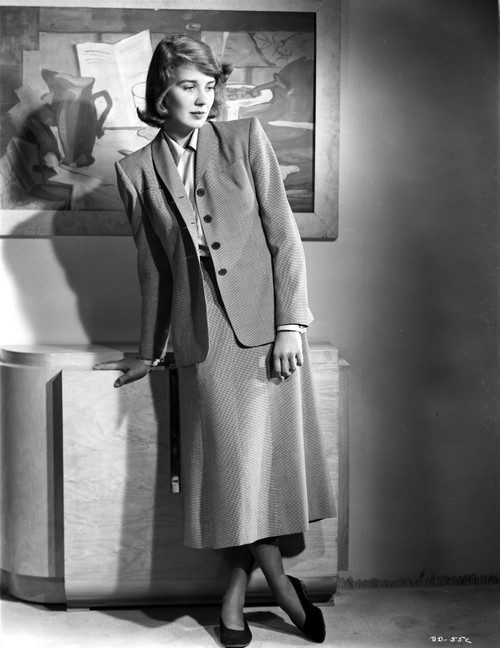 Betsy Drake Posed with Right Hand on the Table Legs Crossed in Grey Suit and Skirt Photo Print - Item # VARCEL697811