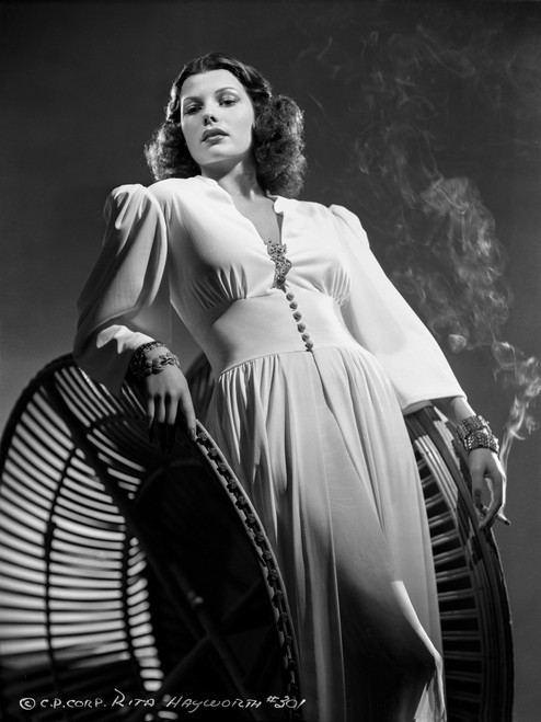 Rita Hayworth Leaning and Smoking Pose Photo Print - Item # VARCEL697987