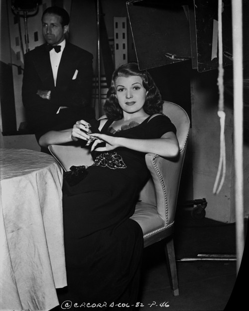 Rita Hayworth Lounging on Chair in Black Gown Photo Print - Item # VARCEL698057
