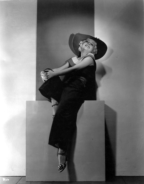 Muruel Evans on a Dark Top and Slacks with Hat sitting Portrait Photo Print - Item # VARCEL698162