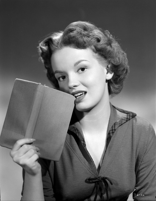 Joan Evans on a Dark Top and Biting The Cover of The Book Portrait Photo Print - Item # VARCEL698189