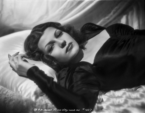 Rita Hayworth Lying on Bed in Black Gown Photo Print - Item # VARCEL698253