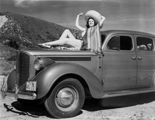 Rita Hayworth posed on the Car in Black and White Photo Print - Item # VARCEL698428