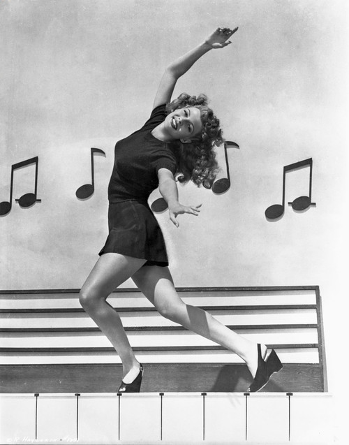 Rita Hayworth Dancing Pose with a Musical Notes Background Photo Print - Item # VARCEL698520