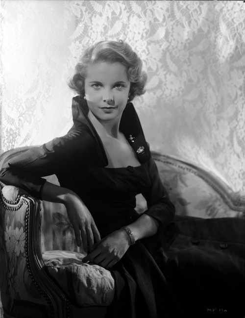 Mona Freeman on a Dark top and Dress sitting on a Couch Portrait Photo Print - Item # VARCEL698752