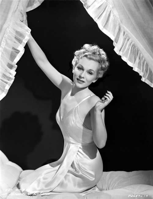 Eva Gabor on Silk Dress sitting on Bed Photo Print - Item # VARCEL698873