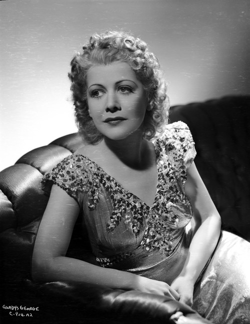 Gladys George on a V-Neck Top sitting on a Couch Photo Print - Item # VARCEL699077