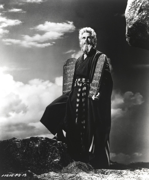 Charlton Heston standing in Red Dress while Carrying Two Holy Stone - A film still from The Ten Commandments Photo Print - Item # VARCEL699262