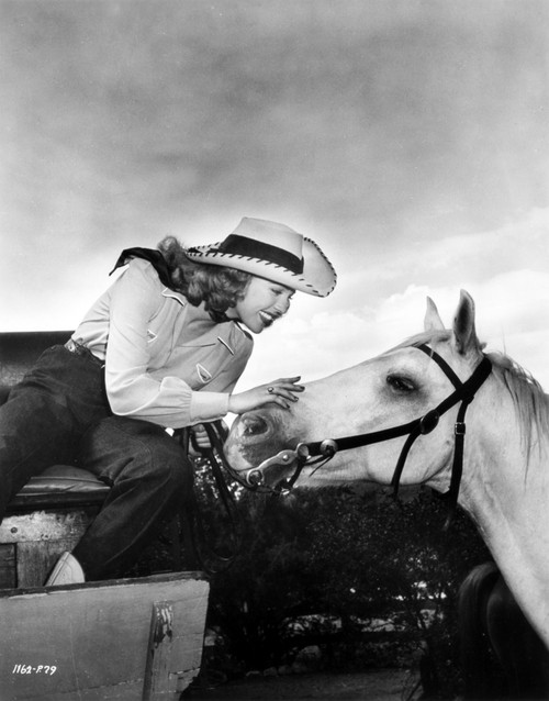 A portrait of Anne Gwynne with a horse Photo Print - Item # VARCEL699551