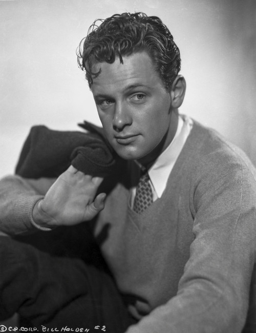 William Holden Posed in Classic Sweater while Holding a Black Coat Photo Print - Item # VARCEL699805