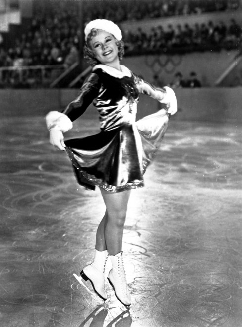 Sonja Henie in Santa Attire while ice skating and swaying Photo Print - Item # VARCEL699862