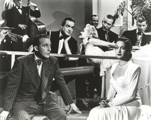 Bob Hope Seated with Woman with Band Performing Behind Photo Print - Item # VARCEL699981