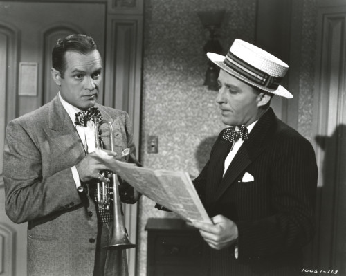 Bob Hope standing in Formal Wear With Man Reading Newspaper Photo Print - Item # VARCEL699987