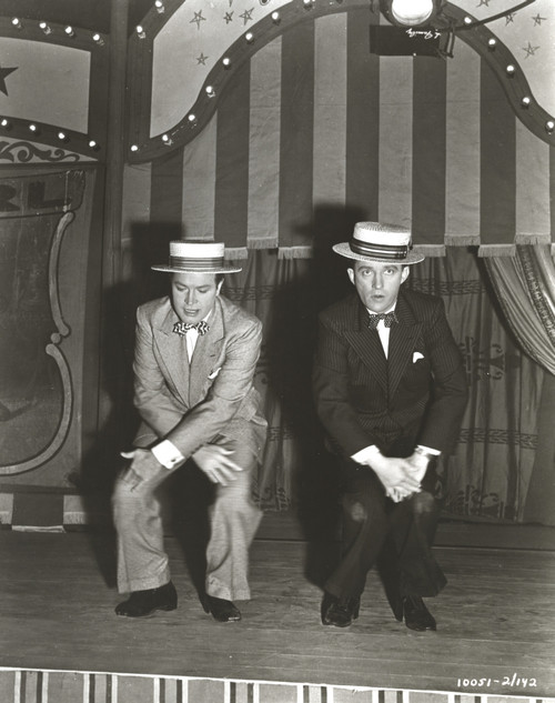 Bob Hope Seated with Man on Stage wearing Tuxedo with Hat Photo Print - Item # VARCEL700035