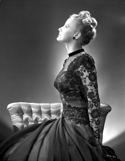 Martha Holliday on an Embroidered Dress sitting on a Couch Photo Print - Item # VARCEL700084