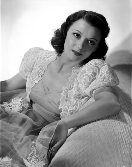 Ann Hunter sitting on the Couch wearing a Blouse Photo Print - Item # VARCEL700274