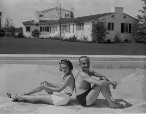 Al Jolson A Couple sitting on the Side of the Pool Photo Print - Item # VARCEL700790