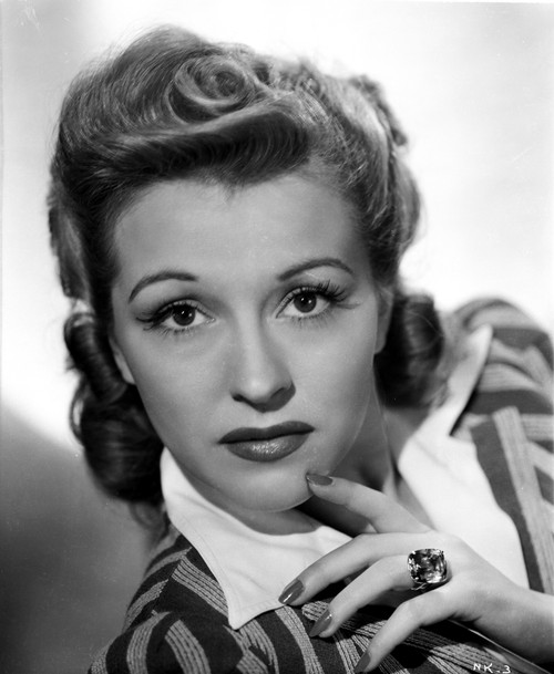 Nancy Kelly on a Stripe Top and Finger on Chin Photo Print - Item # VARCEL700820
