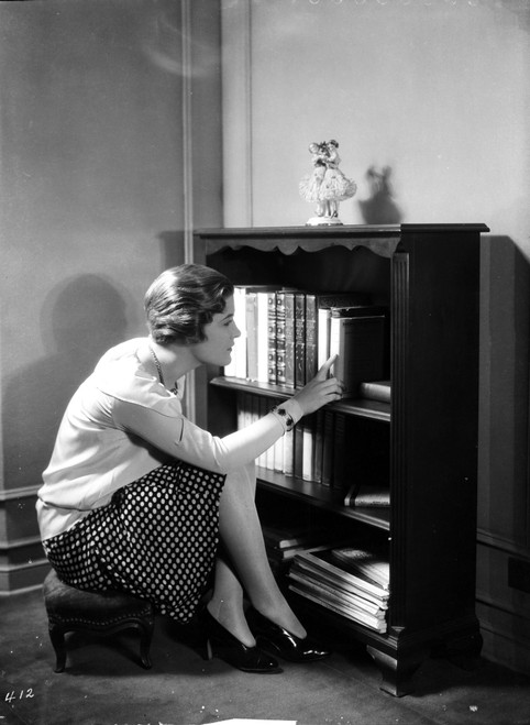 Laura La Plante sitting and Looking for a Book Photo Print - Item # VARCEL701280