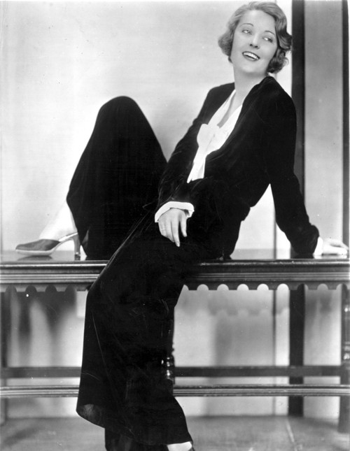 Dorothy MacKail sitting on a table Photo Print - Item # VARCEL701676