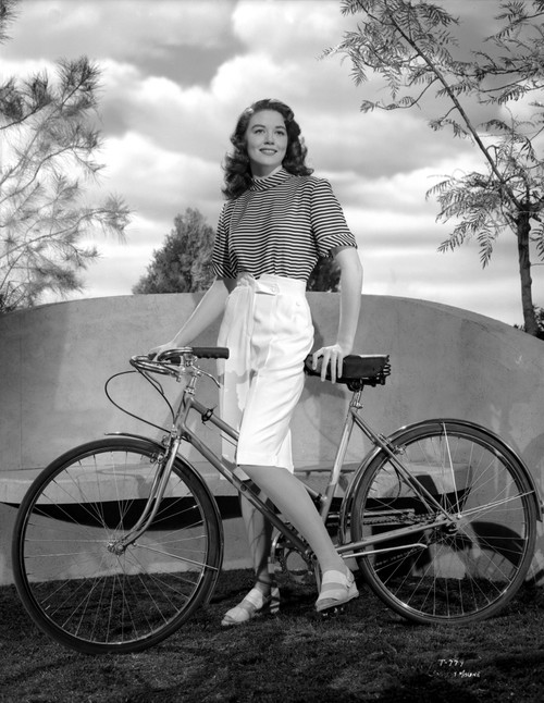 Dorothy Malone on a Printed Top and Holding a Bicycle Photo Print - Item # VARCEL701725