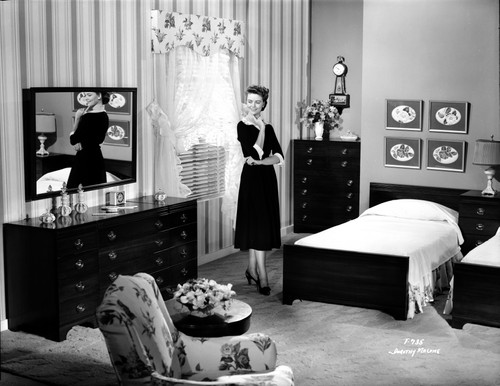 Dorothy Malone on a Dress in a Bedroom posed and smiling Photo Print - Item # VARCEL701733