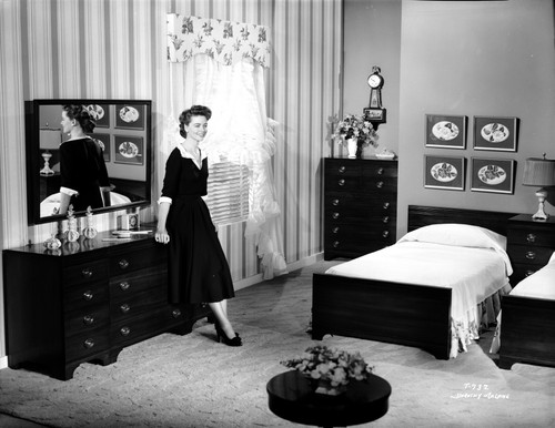 Dorothy Malone on a Dress in a Bedroom sitting and posed Photo Print - Item # VARCEL701735