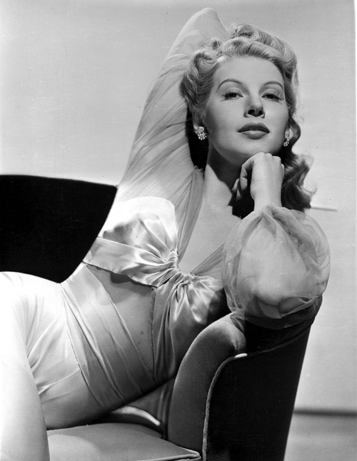 Irene Manning sitting and posed on Couch in Dress Photo Print - Item # VARCEL701741