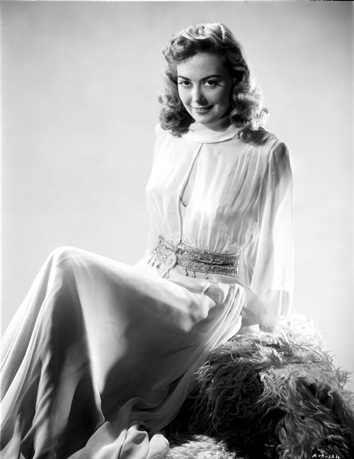 Adele Mara on a Lace Top sitting and smiling Photo Print - Item # VARCEL701755