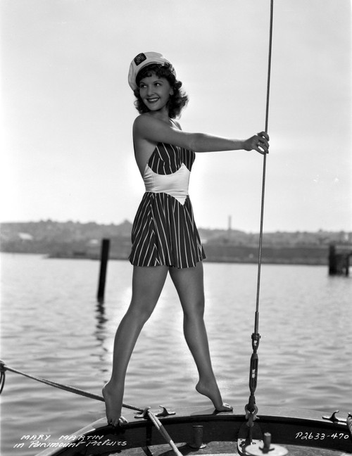 Mary Martin on a Printed Dress standing on a Boat Photo Print - Item # VARCEL701966