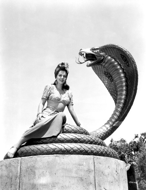 Maria Montez sitting on Snake Statue, wearing Sexy Dress Photo Print - Item # VARCEL702214